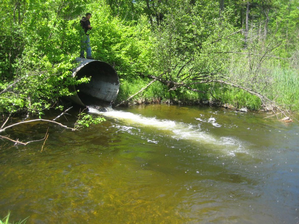 culvert pipe opening out into body of water